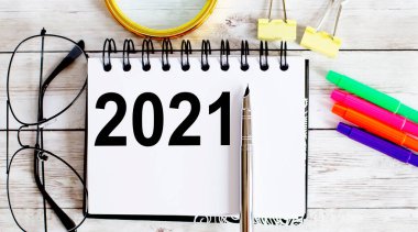 Boş çarşaf, kalem ve bardaklar gri masaya. 2021