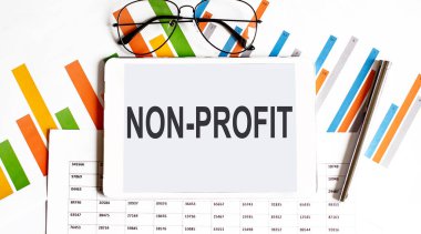 İş grafikleri ve kalem üzerinde Kâr amacı gütmeyen metin tableti