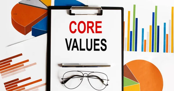 Core Values text . Conceptual background with chart ,papers, pen glasses