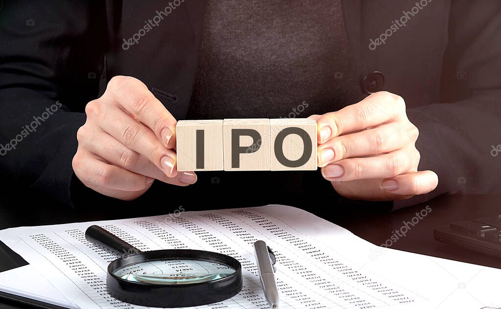 businesswoman holding wooden block with text IPO Initial Public Offering , business