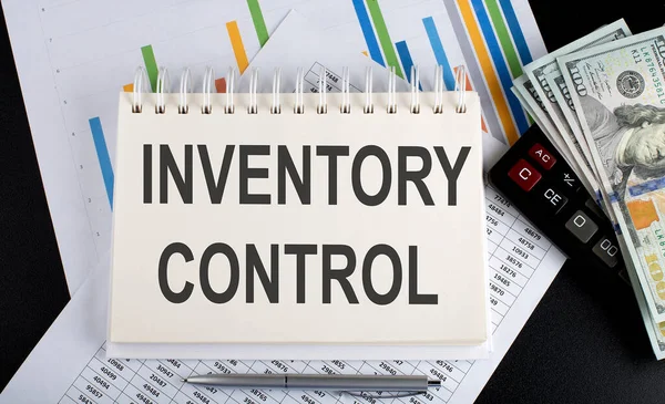 INVENTORY CONTROL text written on notebook with chart,calculator and dollars