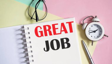 Defterde harika bir iş çıkardın. Kalemle. Pembe arka planda çalar saat.