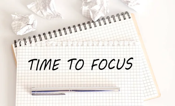 TIME TO FOCUS - text is written on the Notepad with pen