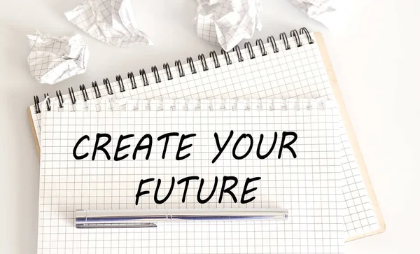 Create Your Future - the text is written on Notepad with pen