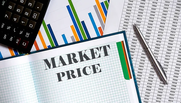 Calculator , chart, notepad, paper and pen on the table. Text MARKET PRICE