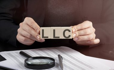 İş kadını ahşap bloğu LLC ile tutuyor, iş yeri