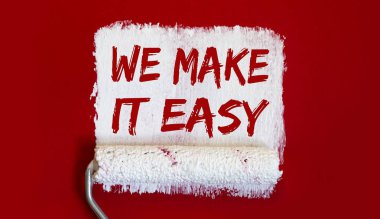 Kolaylaştırırız. Kırmızı arka planda beyaz fırçalı bir kutu boya..