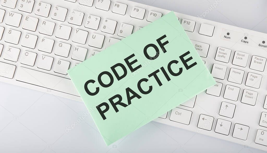 text Code of Practice on envelope on keyboard on white background