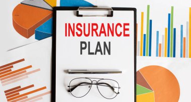 Insurance plan text . Conceptual background with chart ,papers, pen and glasses, business concept