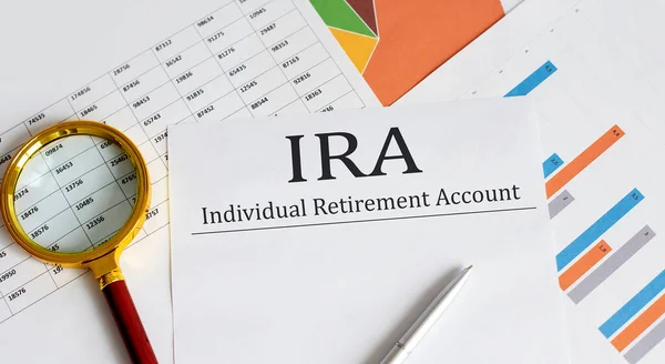 Paper with IRA on table with charts