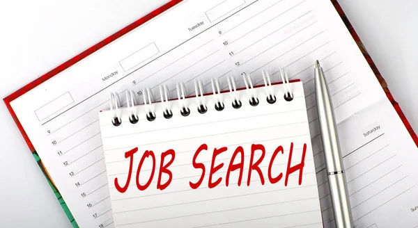 JOB SEARCH text on the notebook on diary,business concept