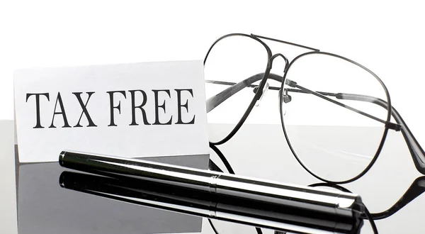 Text Tax Free White Sticker Paper Light Background Pen Glasses — Stock fotografie