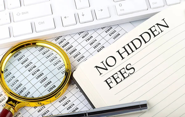 No Hidden Fees text on notebook with chart, magnifier,keyboard and pen