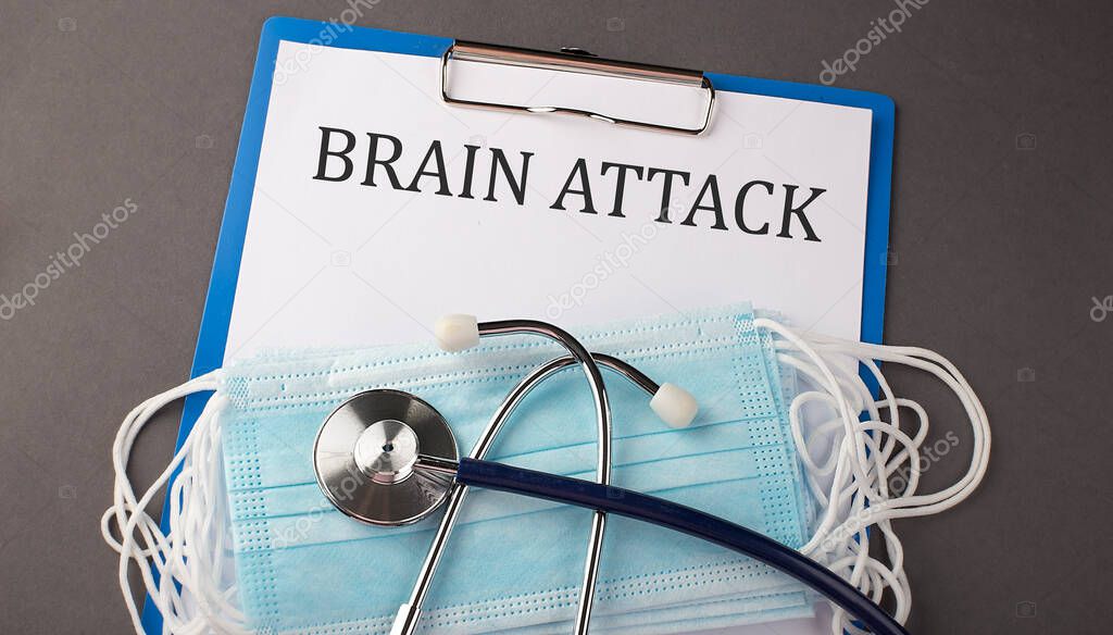 Folder with paper text BRAIN ATTACK , on a table with a stethoscope and medical masks, medical