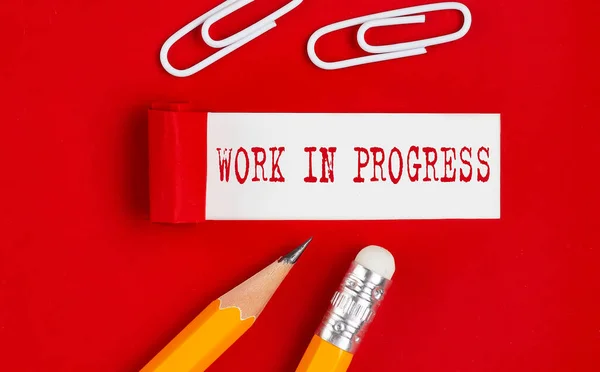 Work Progress Message Written Torn Red Paper Pencils Clips — Stock Photo, Image