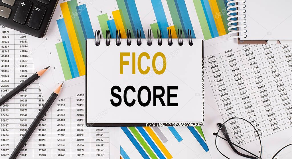 Closeup a notebook with text FICO SCORE , business concept image on the chart background