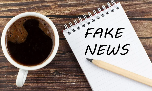 Fake News Text Notebook Coffee Wooden Background — Stockfoto