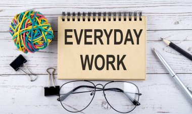 Her gün mesai ve ofis malzemeleriyle dolu bir defter. Yukarıdan bak. Beyaz arkaplanda yakın plan