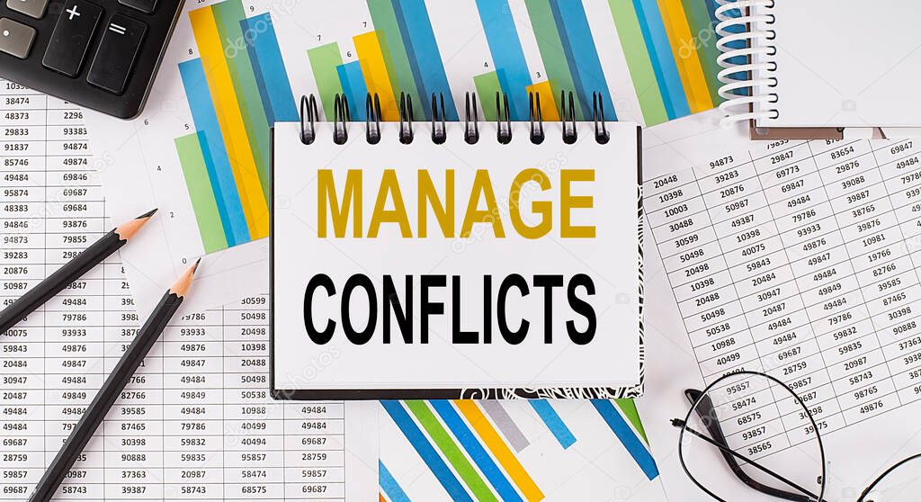 Closeup a notebook with text Managing Conflicts , business concept image on the chart background