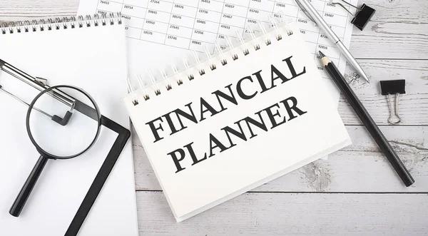 FINANCIAL PLANNER . Text written on the notepad with office tools and documents.