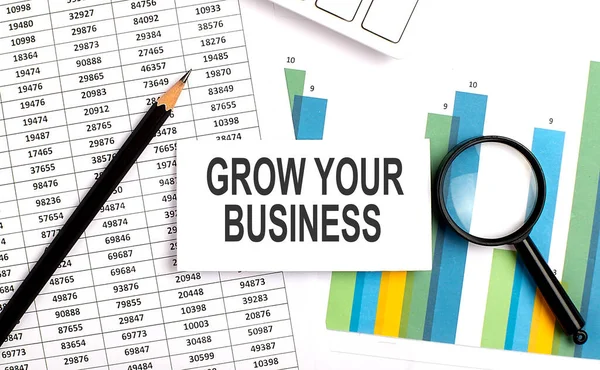 GROW YOUR BUSINESS text on white card on chart background