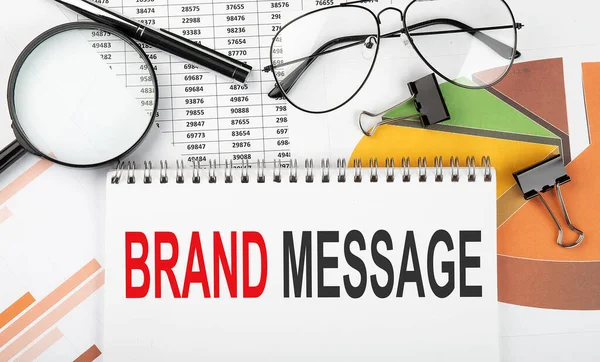 Text BRAND MESSAGE on white paper notebook on the diagram. Business