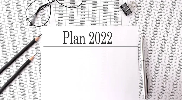 Paper with PLAN 2022 on table on charts