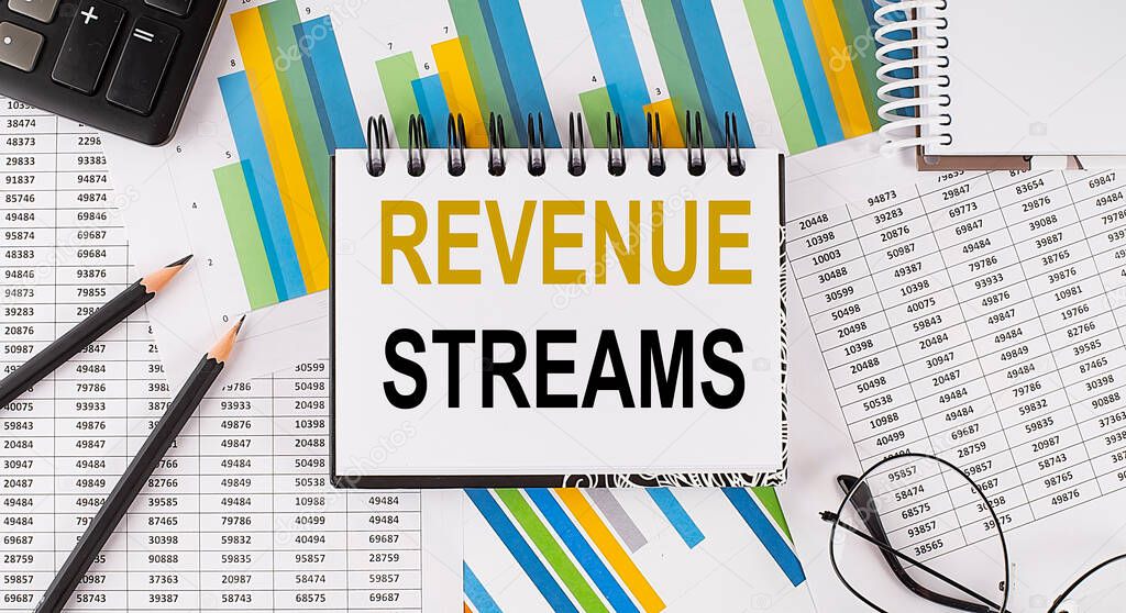 Closeup a notebook with text REVENUE STREAMS , business concept image on the chart background