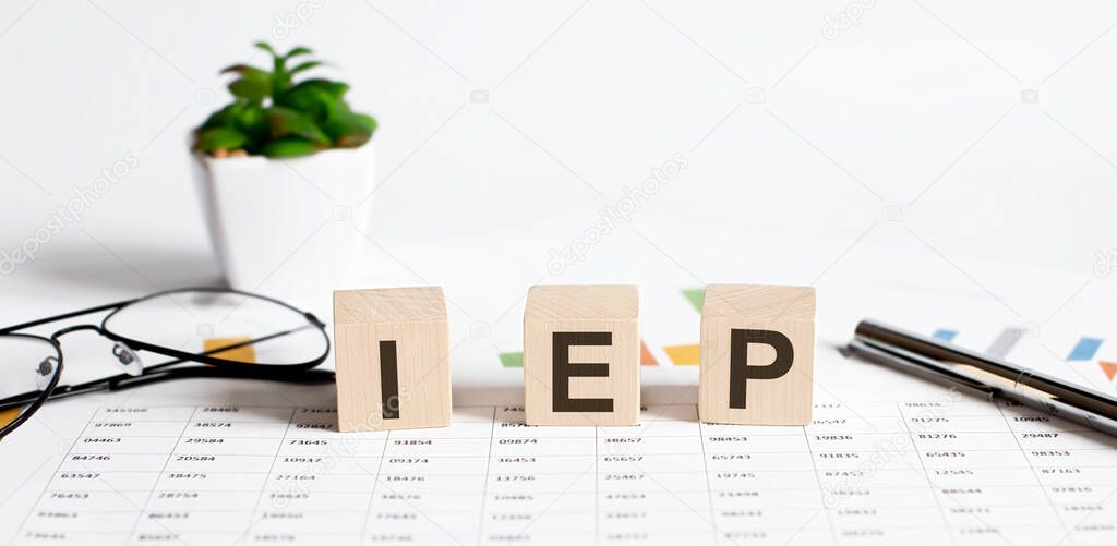 Wooden blocks written with IEP stands for Individualized Educational Program on chart