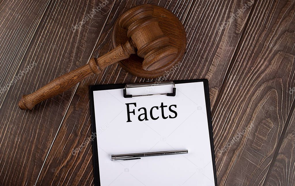 FACTS text on paper with gavel on the wooden background