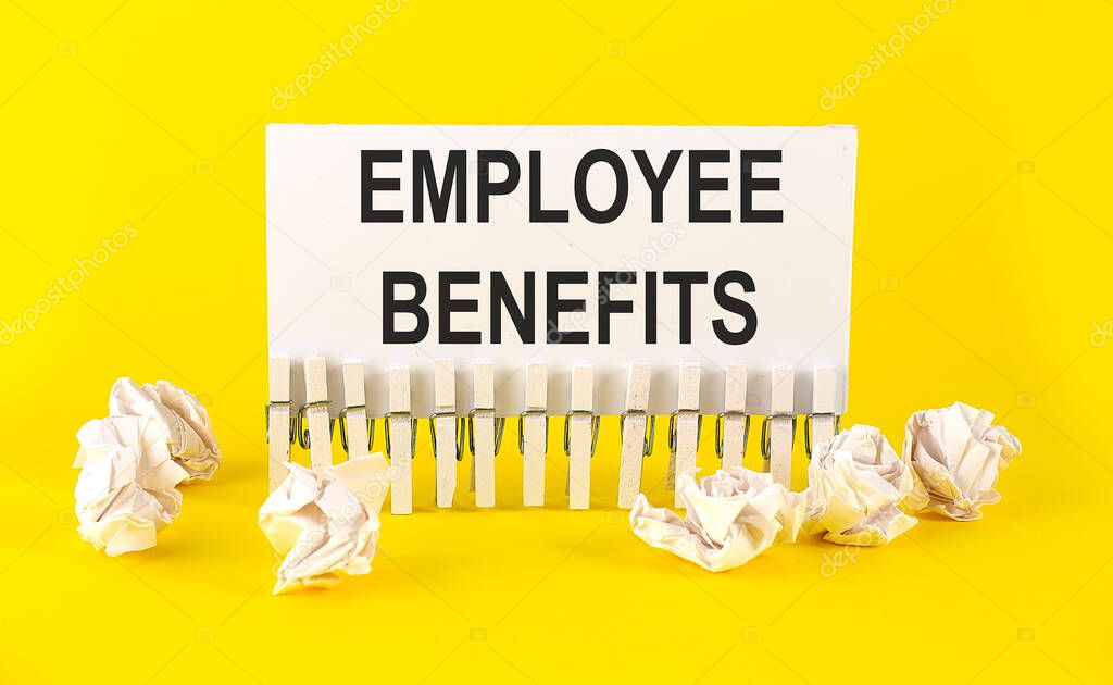 white paper on the yellow background with text EMPLOYEE BENEFITS