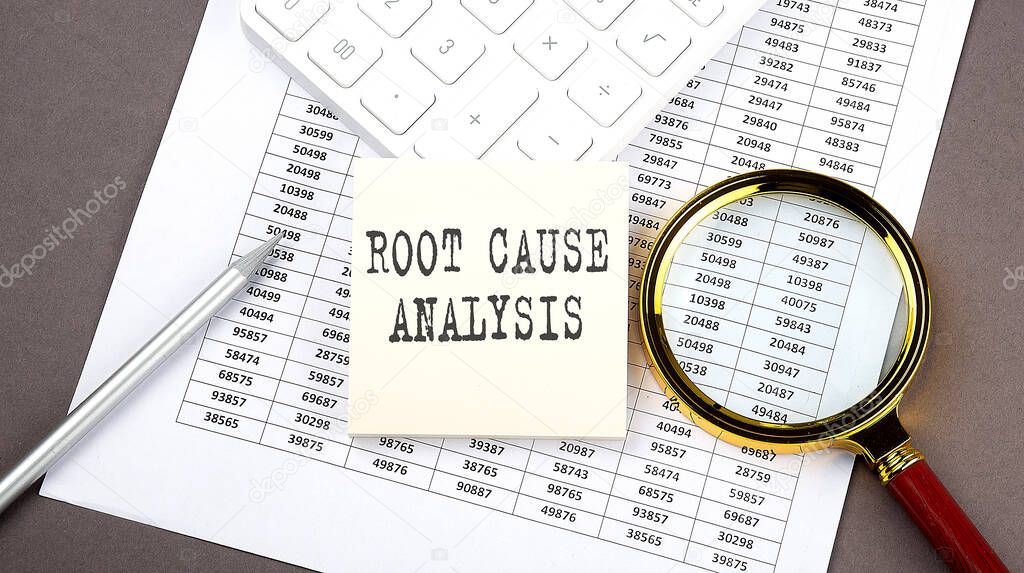 ROOT CAUSE ANALYSIS text on sticker on chart ,with calculator and magnifier