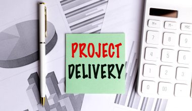 Ofis masasında dosya, kalem ve beyaz hesap makinesi olan metin projeli kağıt . 