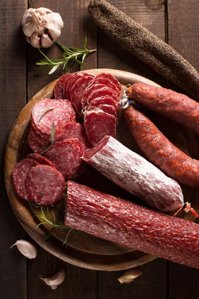 Assortment of sausages on cutting board — Stock Photo, Image