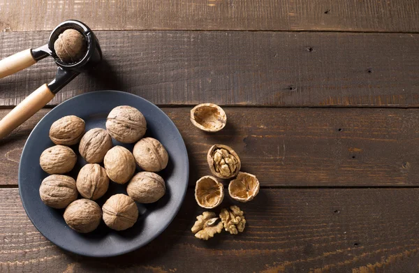 Walnuts with nutcracker — Stock Photo, Image