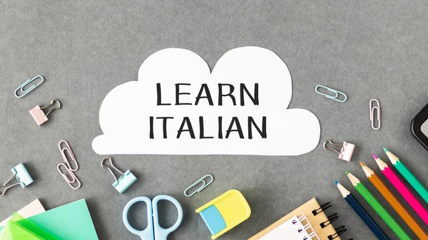 Learn Italian text written on a paper with pencils in office