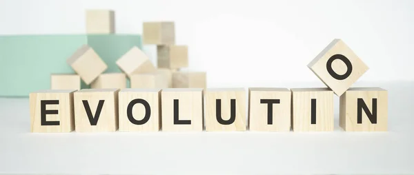 evolution letters on block on white paper background, in concept of business and corporation