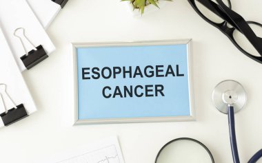 Esophageal Cancer write on a book isolated on office desk. clipart