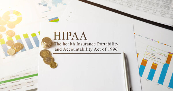Paper with HIPAA The Health Insurance Portability and Accountability Act of 1996 on a table