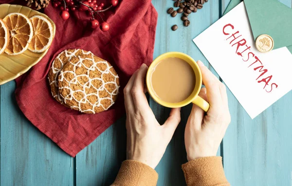 Hands, Cup of cappuccino on a Christmas table decorated