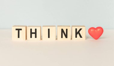 Tahta bir masanın üzerinde yeşil bir doğaya sahip küp bloklarda mesajlaşmayı düşün.