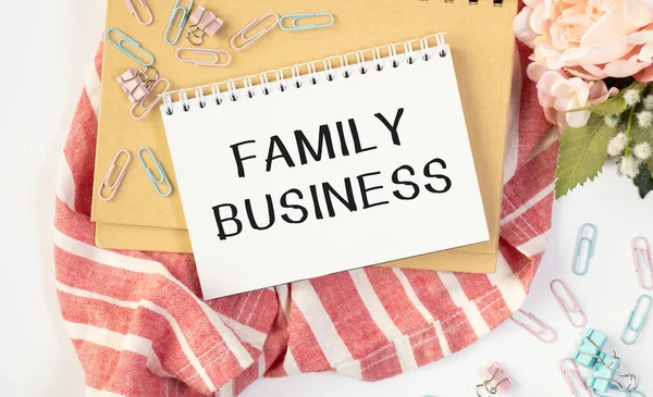 FAMILY BUSINESS concept write text on notebook