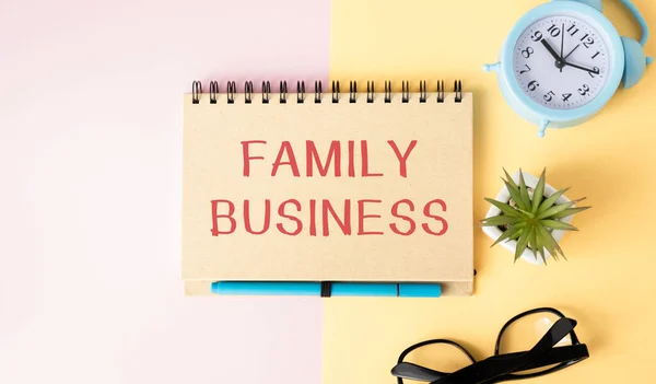 FAMILY BUSINESS concept write text on notebook