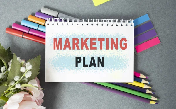 Notebook with Tools and Notes about Marketing Plan, business concept.