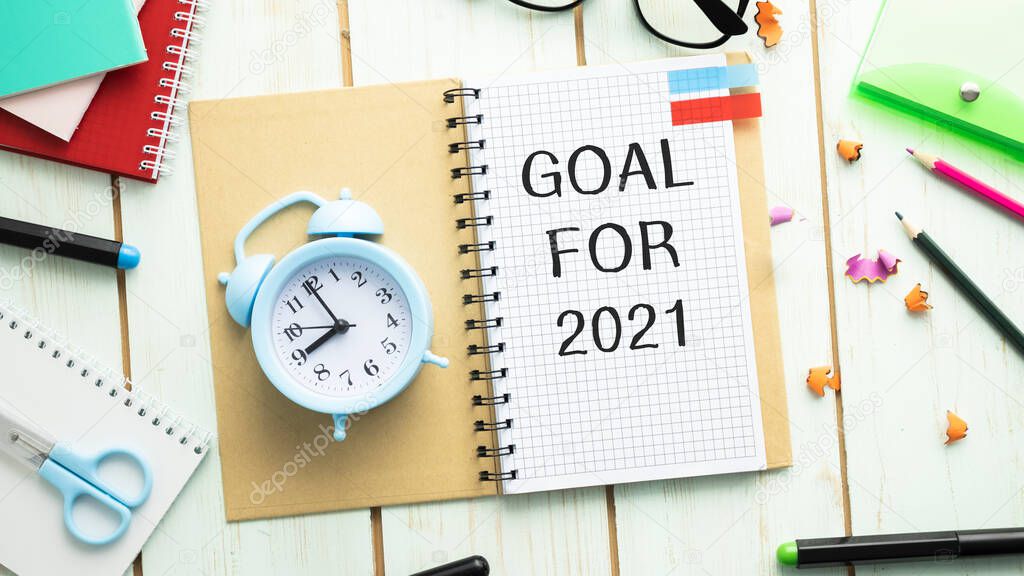 goal 2021 Top view flat lay of desktop and notepads writing down goals and plans. 2021 New Year's goal, plan,action text on notepad with office accessories. Business motivation, inspiration concept.
