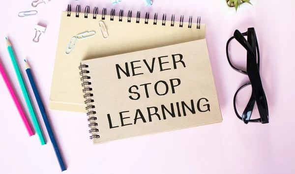 Never stop learning memo written on a notebook with pen