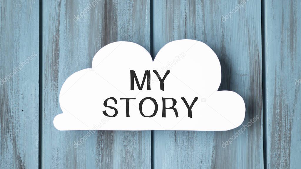 White card in cloud shape with text My Story on stylish wooden background