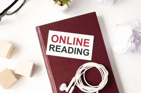 online reading written on card on red notebook, online concept.