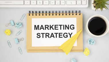 Pazarlama stratejisi kavramı. Ofis masasında metin pazarlama stratejisi olan not defteri.