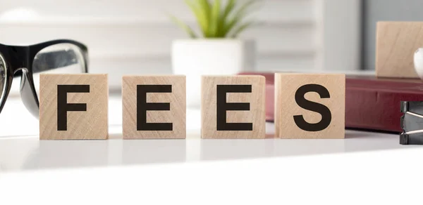 FEES - financial business concept. Blocks of wood cubes